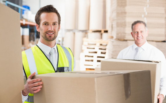 Delivery driver loading his van with boxes outside the warehouse